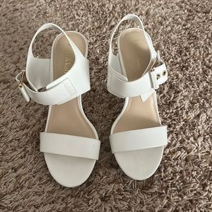 White dress sandals with 3.5 inch heel, gold accents on buckle